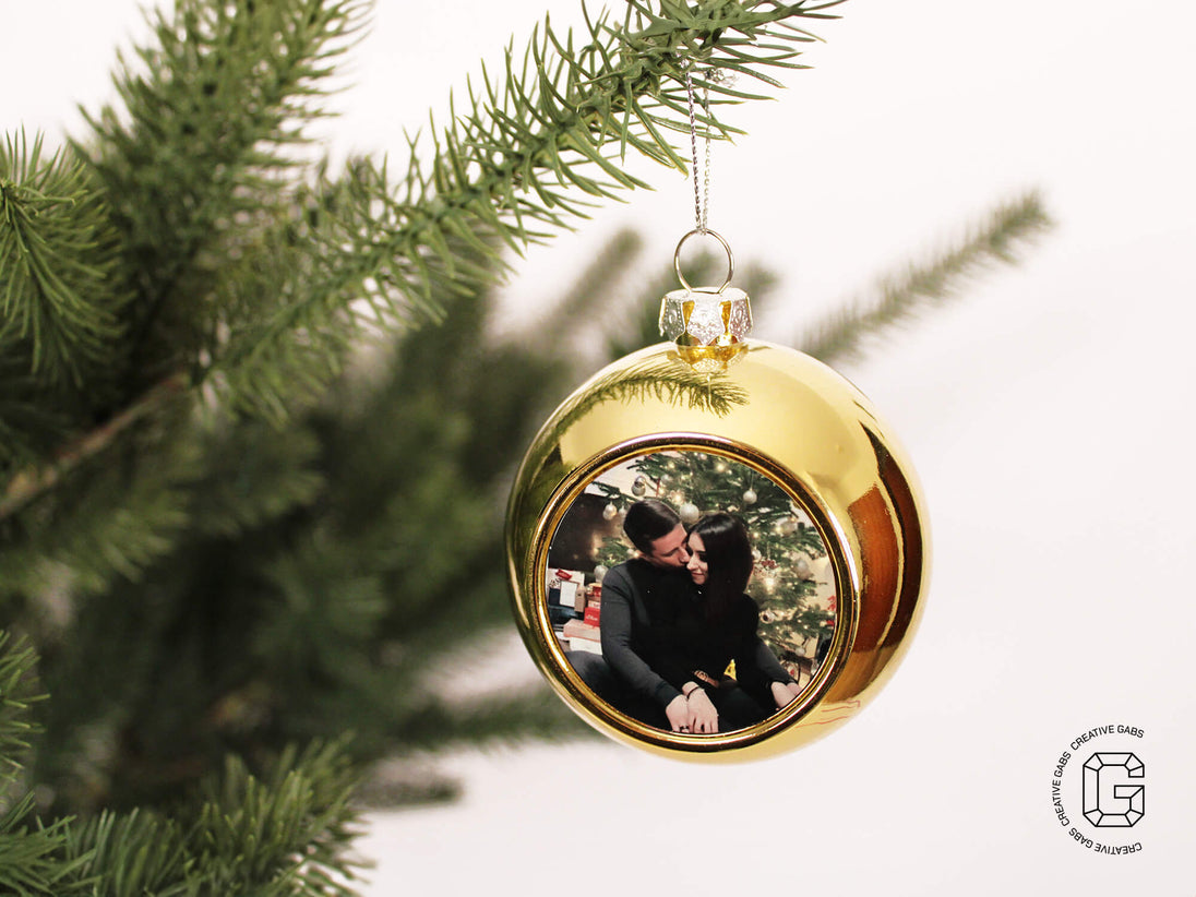 Personalisierte goldene Weihnachtskugel mit Foto – festlich am geschmückten Weihnachtsbaum aufgehängt