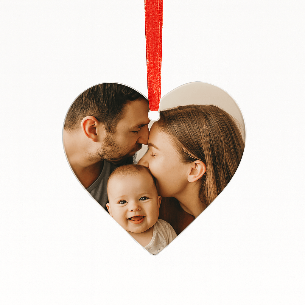 Personalisierte herzförmige Acryl-Weihnachtskugel mit Familienfoto – rotes Band, vor weißem Hintergrund